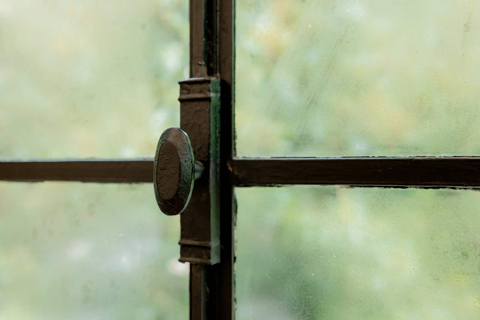Close-up of a window latch on a steel-framed window